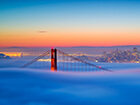 Golden Gate Bridge in fog at sunrise 