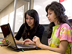 two-college-students-collaborating-in-library