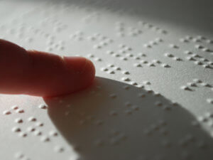 closeup of person reading braille