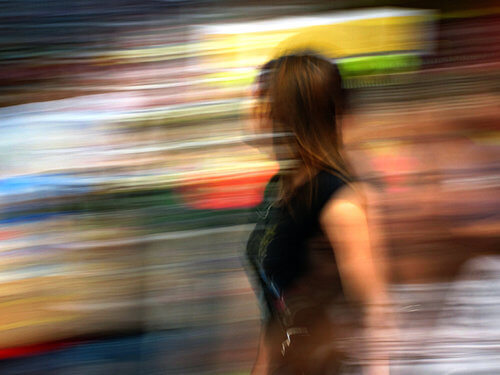 blurred photo of woman walking in city