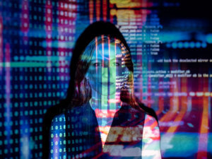 photo of a woman with software code projected in multicolor