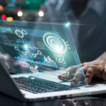 person using laptop with graphic overlay that suggests data science or data management