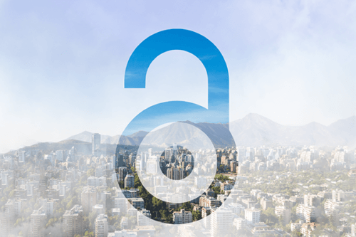photo of a city skyline with a mountain in the background with the open access symbol overlaid on top 