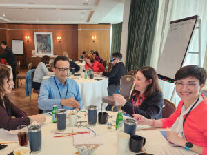 candid photo of professionals sitting at a table and talking