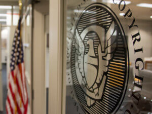 interior photo of US Copyright Office showing government seal on door and American flag