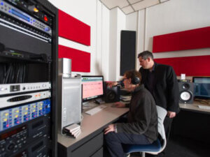 photo of two people working in a recording studio 