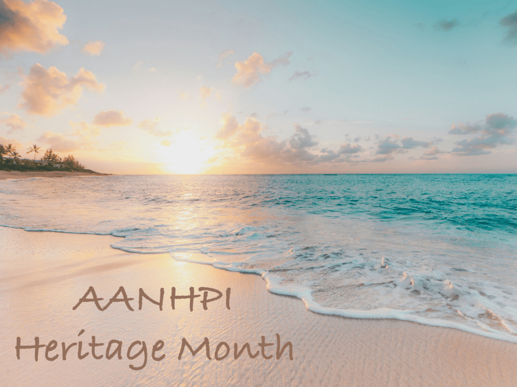 photo of a beach on Oahu, Hawaii, with "AANHPI Heritage Month" written on the sand