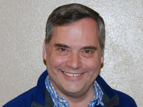Image is a professional head shot of Mark Emmons, incoming dean of the University of New Mexico's College of University Libraries and Learning Sciences 