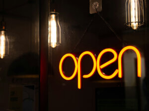 photo of yellow neon "open" sign at night