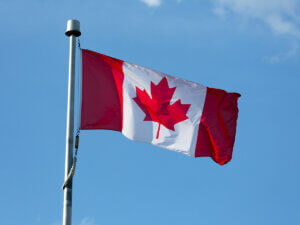 photo of Canadian flag flying on a sunny day 
