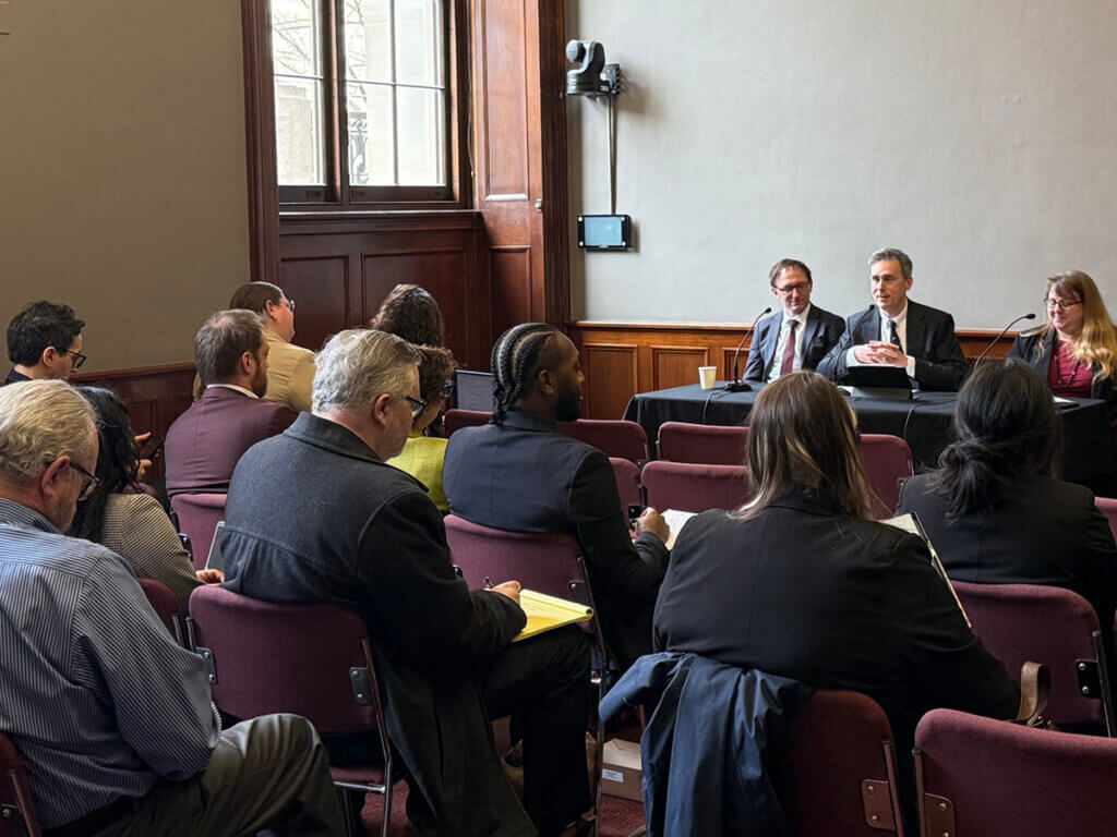 photo of Dave Hansen, Brandon Butler, and Betsy Rosenblatt speaking in front of an audience